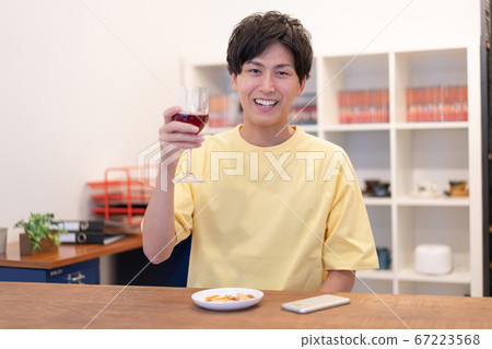 Screen of a man in his 20s toasting at an online drinking party Screen of a man in his 20s toasting at an online drinking party 67223568