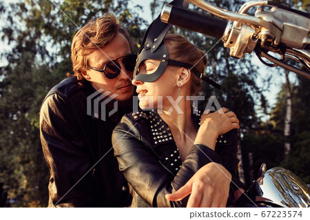 Sexy couple of bikers on the vintage custom motorcycle, girl in a rabbit mask Sexy couple of bikers on the vintage custom motorcycle, girl in a rabbit mask 67223574