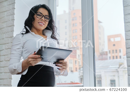 Beautiful fashionable business woman with digital tablet Beautiful fashionable business woman with digital tablet 67224100