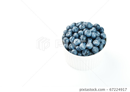 Juicy and ripe Blueberries in a white plate on a white background 67224917