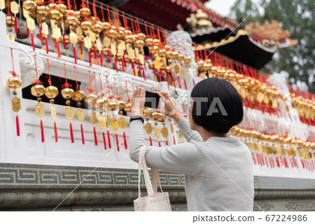 woman take a picture at the golden bells woman take a picture at the golden bells 67224986