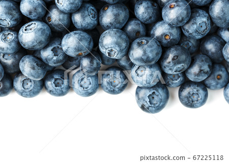 Tasty blueberries fruit are scattered on a white background. Frame 67225118