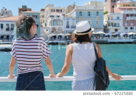 Mediterranean, people women backs near sea promenade, 67225880