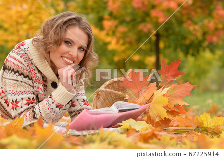 Portrait of young woman resting in park 67225914