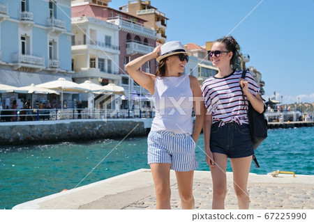 Happy mother and daughter teenager walking, summer sea vacation 67225990