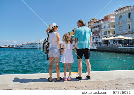 Tourist family back view, summer sea holidays Tourist family back view, summer sea holidays 67226021