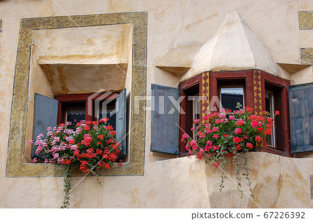 Ancient balcony with windows and flowers - Ardez village Engadine Switzerland 67226392