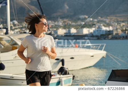 Sporty mature woman jogging running at promenade 67226866