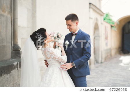 Luxury married wedding couple, bride and groom posing in old city 67226958