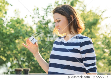Outdoor middle-aged woman with medicine, vitamins, supplements 67227293