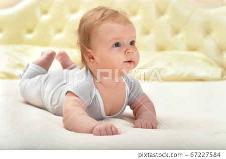 Portrait of cute little baby girl on bed Portrait of cute little baby girl on bed 67227584