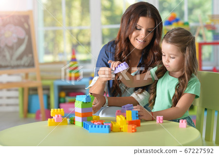 Portrait of little girl playing with mother Portrait of little girl playing with mother 67227592