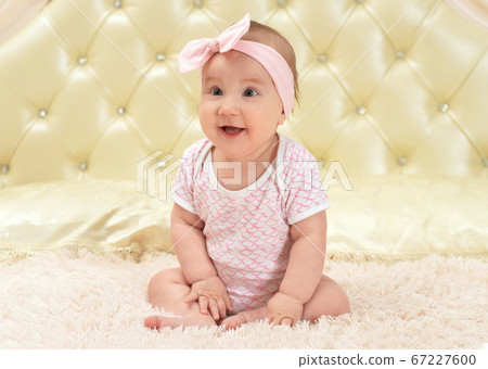 Portrait of cute little baby girl on bed Portrait of cute little baby girl on bed 67227600