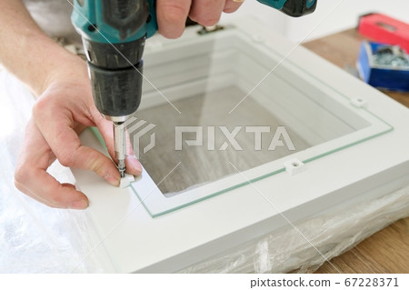 Closeup of workers hand with professional tools and furniture details Closeup of workers hand with professional tools and furniture details 67228371