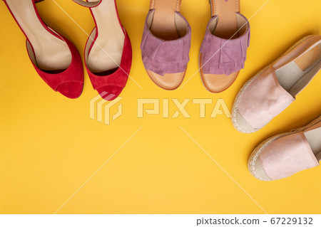 Different shoes on a yellow background with copy space, flat lay. Beauty blog concept. Different shoes on a yellow background with copy space, flat lay. Beauty blog concept. 67229132
