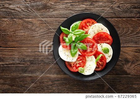 Caprese salad. Salad with mozzarella cheese, fresh Caprese salad. Salad with mozzarella cheese, fresh 67229365