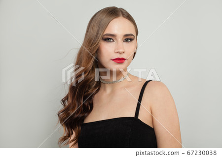 Beautiful young woman with red lips makeup Beautiful young woman with red lips makeup 67230038
