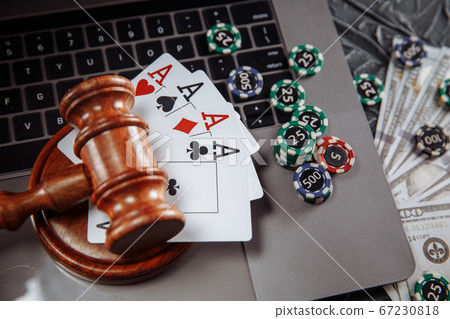 Judge wooden gavel, money banknotes and playing cards on computer keyboard, legal rules for online gambling concept Judge wooden gavel, money banknotes and playing cards on computer keyboard, legal rules for online gambling concept 67230818