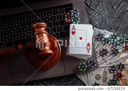 Judge's gavel, poker chips and playing cards. Concept of Law and regulation of gambling Judge's gavel, poker chips and playing cards. Concept of Law and regulation of gambling 67230819
