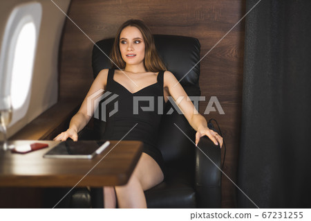 Attractive woman in private jet 67231255