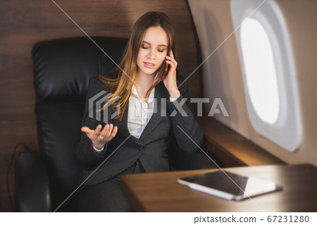Attractive woman in private jet 67231280