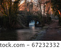 Frozen nature on the river trail and old stone bridge 67232332