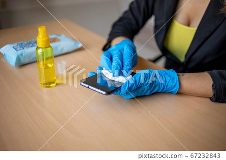 Woman's hand in blue gloves sanitizing cleaning Woman's hand in blue gloves sanitizing cleaning 67232843
