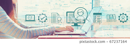 Document management system concept with woman working on a laptop 67237164