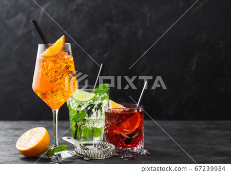 Glasses of spritz,mojito and negroni cocktails Glasses of spritz,mojito and negroni cocktails 67239984