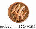 Turmeric roots in bowl isolated on white background 67240193