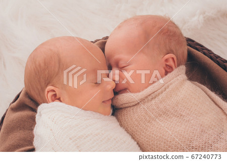 IVF results: The twins embrace. newborn babies sleep together 67240773