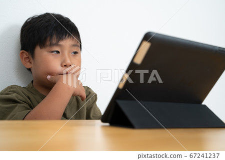 Boy watching tablet Boy watching tablet 67241237