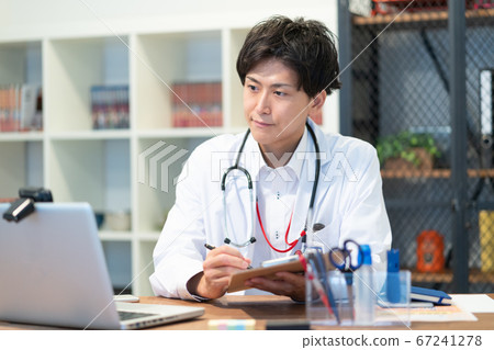 Young male doctor doing online medical treatment 67241278