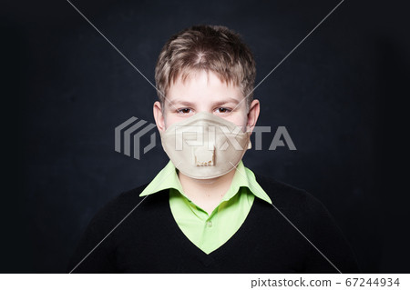 Young boy in protective medical mask on black 67244934