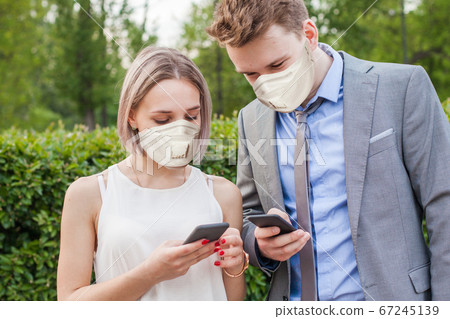 Young woman and man wearing medical mask  67245139