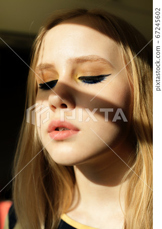 Girl with black eyeliner makeup in day light 67245602