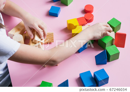 Little kid plays assemble with wooden cubes constructor. Education concept for children learning. Children's toys 67246034