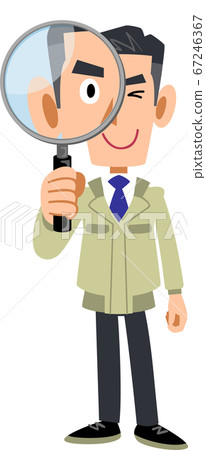 A man in work clothes looking through a magnifying glass 67246367
