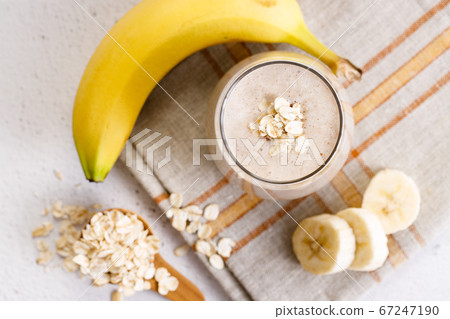 banana and oatmeal smoothie in a glass 67247190