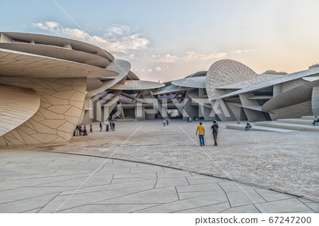 Doha, Qatar-October 25,2019 :National Museum of Qatar (Desert rose) exterior  daylight view with clouds in sky 67247200