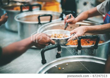 Feeding the poor to hands of a beggar, feeding Feeding the poor to hands of a beggar, feeding 67247313