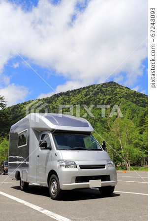 A refreshing blue sky and a camper car trip 67248093