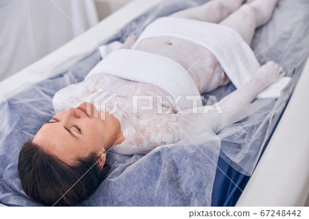Calm lady enjoying dry floating in the spa Calm lady enjoying dry floating in the spa 67248442