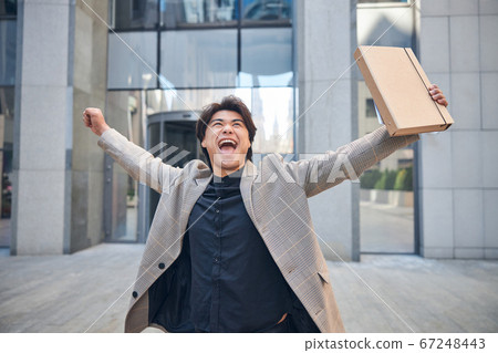 Cheerful young man with documents rejoicing on the street Cheerful young man with documents rejoicing on the street 67248443