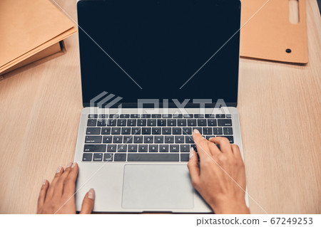Female hands are working on modern laptop Female hands are working on modern laptop 67249253