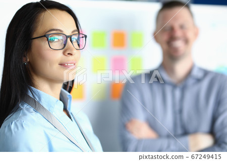 Business woman in glasses on background of smiling man 67249415