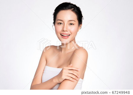 Beautiful smiling young asian woman with clean skin, natural make-up, and white teeth on white Beautiful smiling young asian woman with clean skin, natural make-up, and white teeth on white 67249948