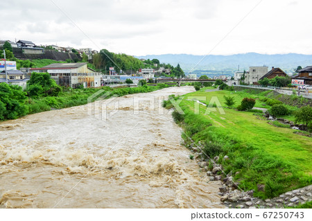 Tenryu river after heavy rain in Iida city Tenryu river after heavy rain in Iida city 67250743