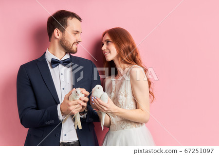 Nice married couple with two white pigeons Nice married couple with two white pigeons 67251097