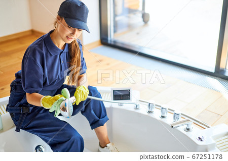 Woman from cleaning service cleaning bath at home Woman from cleaning service cleaning bath at home 67251178